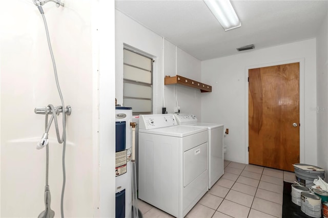 5507 SE 107th Pl, Belleview, FL 34420 - laundry room with electric water heater, separate washer and dryer, light tile patterned floors, laundry area, and visible vents