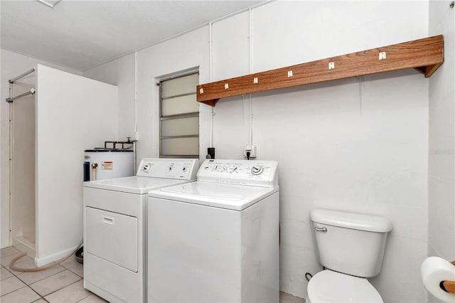 5507 SE 107th Pl, Belleview, FL 34420 - washroom with washing machine and dryer, water heater, laundry area, and light tile patterned floors