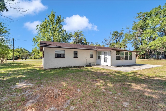 5507 SE 107th Pl, Belleview, FL 34420 - back of house with stucco siding, a yard, a patio, and central AC