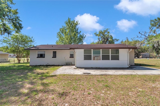 5507 SE 107th Pl, Belleview, FL 34420 - back of property featuring stucco siding, a patio area, cooling unit, and a lawn
