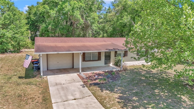 5507 SE 107th Pl, Belleview, FL 34420 - ranch-style home featuring a front lawn, a porch, concrete driveway, an attached garage, and stucco siding