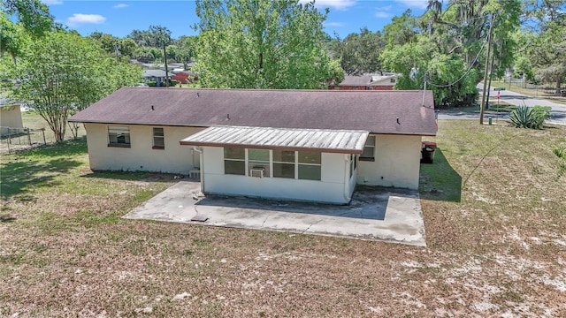 5507 SE 107th Pl, Belleview, FL 34420 - rear view of house with fence, a patio, a yard, and stucco siding