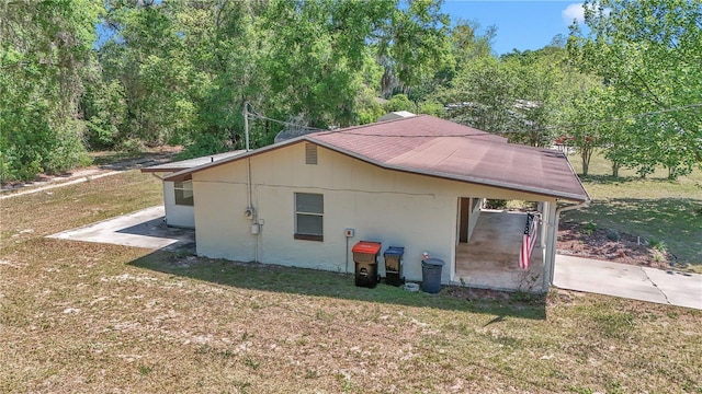 5507 SE 107th Pl, Belleview, FL 34420 - view of home's exterior featuring a lawn and an attached carport