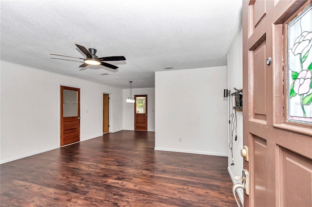 5507 SE 107th Pl, Belleview, FL 34420 - foyer entrance featuring a textured ceiling, visible vents, dark wood-style floors, and ceiling fan