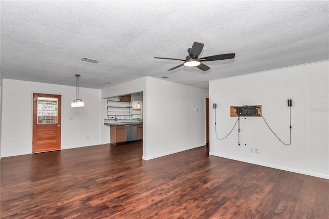 5507 SE 107th Pl, Belleview, FL 34420 - unfurnished living room featuring a textured ceiling, ceiling fan, dark wood finished floors, baseboards, and visible vents