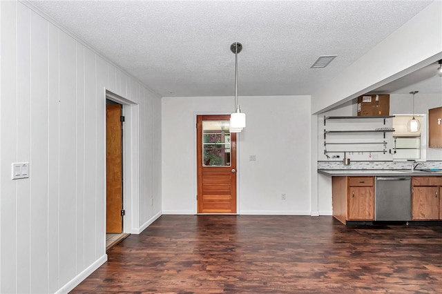 5507 SE 107th Pl, Belleview, FL 34420 - kitchen with brown cabinetry, stainless steel dishwasher, a textured ceiling, and dark wood-style floors
