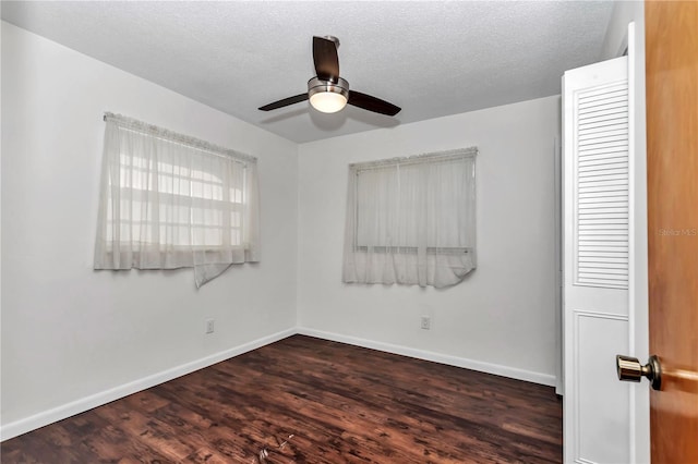 5507 SE 107th Pl, Belleview, FL 34420 - empty room featuring dark wood-type flooring, a textured ceiling, a ceiling fan, and baseboards