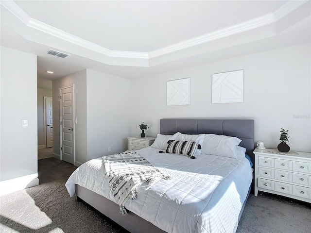 carpeted bedroom with a raised ceiling and ornamental molding