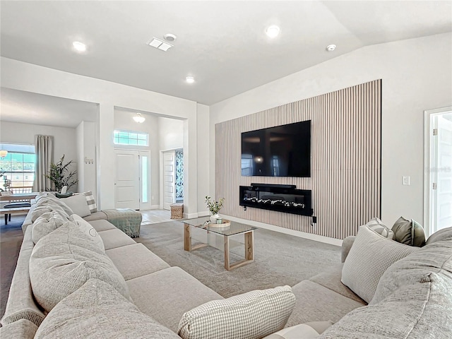 living room featuring lofted ceiling