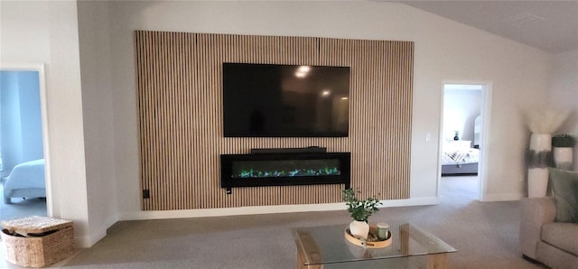 living room featuring carpet and vaulted ceiling