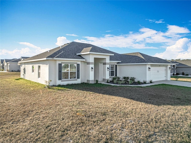 view of front of home with a front lawn and a garage