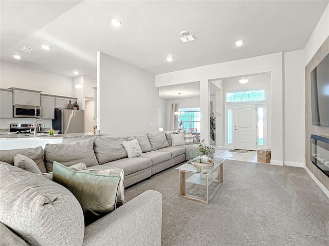 living room with sink and light carpet