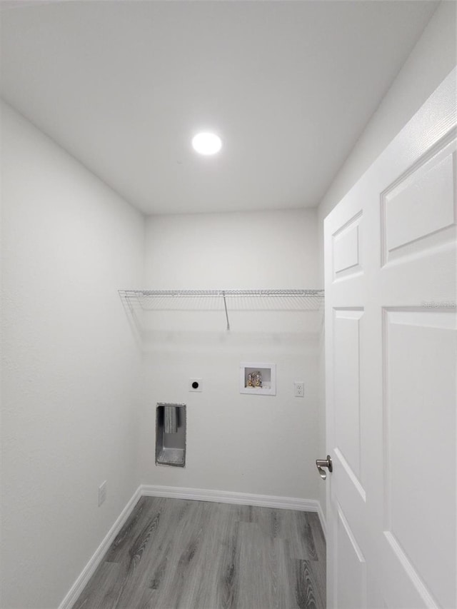 clothes washing area with hardwood / wood-style floors, electric dryer hookup, and washer hookup