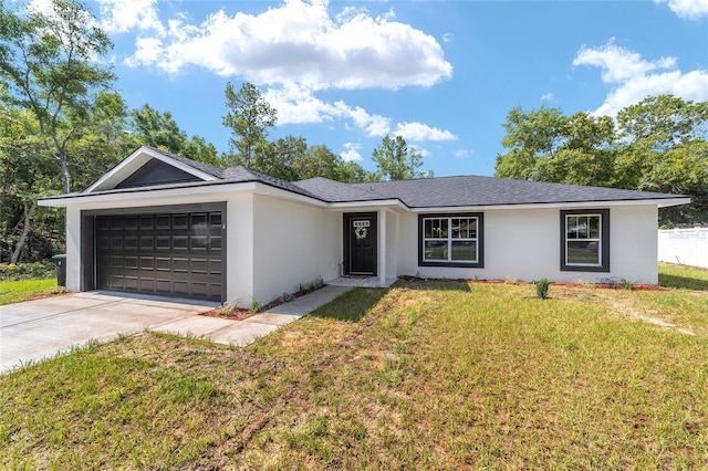 ranch-style home featuring a garage and a front lawn