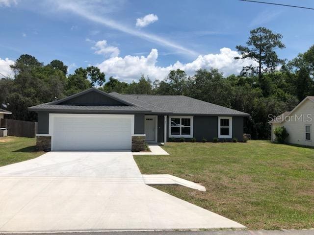 single story home with a garage and a front yard