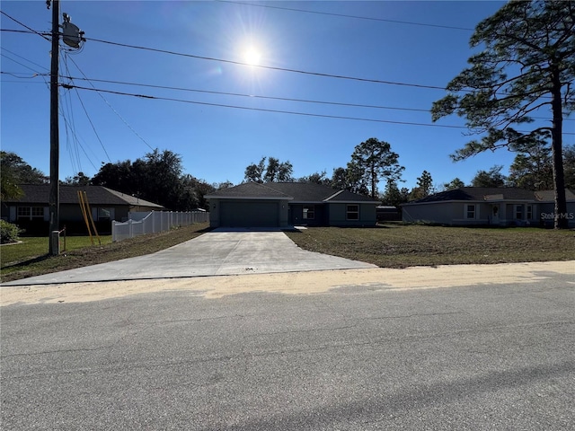 view of front of house with a front yard and a garage