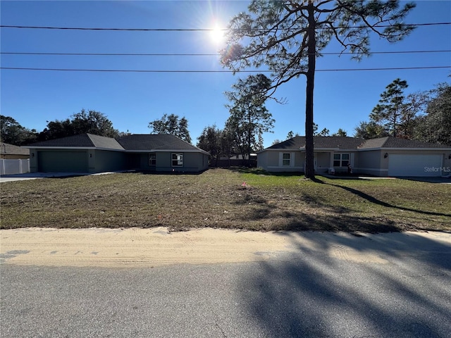 view of front of house featuring a garage and a front lawn