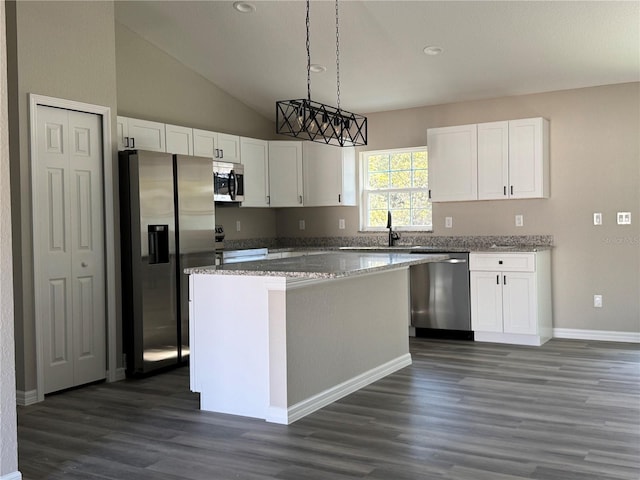 kitchen featuring pendant lighting, a kitchen island, white cabinetry, and appliances with stainless steel finishes