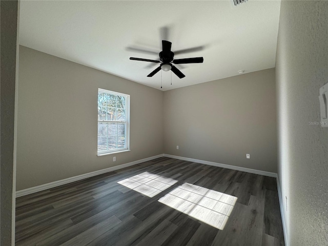 unfurnished room with ceiling fan and dark hardwood / wood-style floors