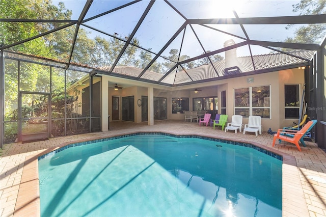 view of pool with a lanai, ceiling fan, and a patio area