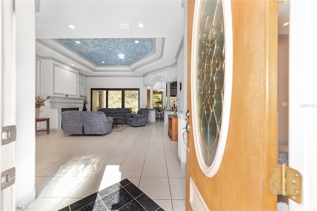 interior space with a tray ceiling and crown molding