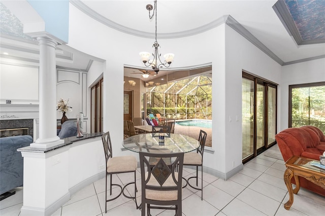 tiled dining room with decorative columns, crown molding, vaulted ceiling, and an inviting chandelier