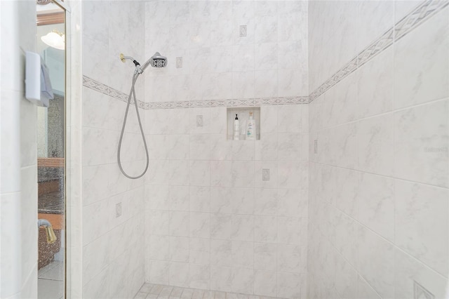 bathroom with tiled shower