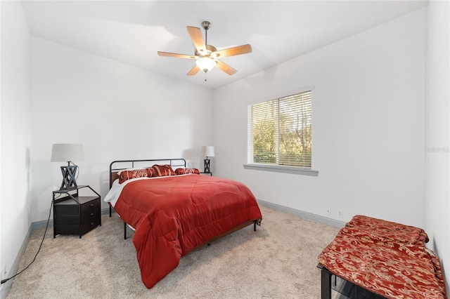 bedroom featuring ceiling fan and carpet