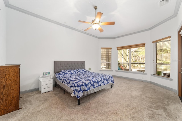 carpeted bedroom featuring ceiling fan and ornamental molding