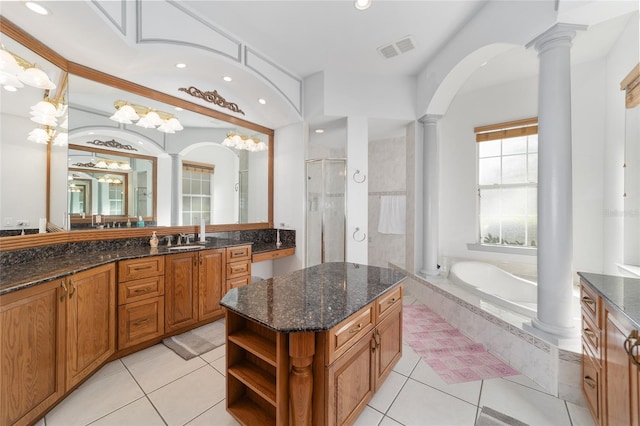 bathroom featuring tile patterned floors, separate shower and tub, decorative columns, and vanity