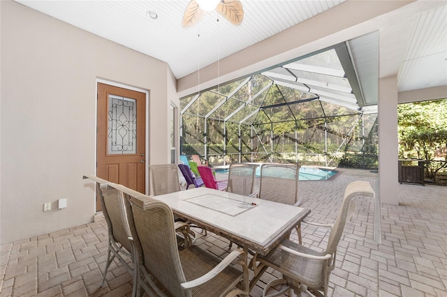 view of patio featuring a lanai and ceiling fan