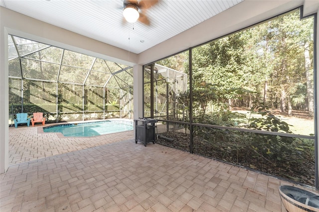 view of pool featuring a lanai, a patio area, and ceiling fan