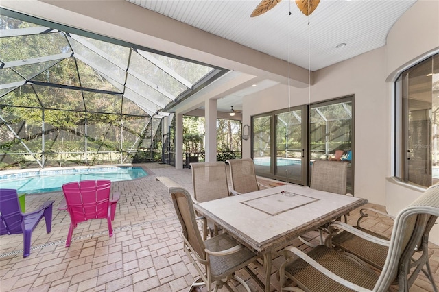 sunroom / solarium with ceiling fan, lofted ceiling, and a pool