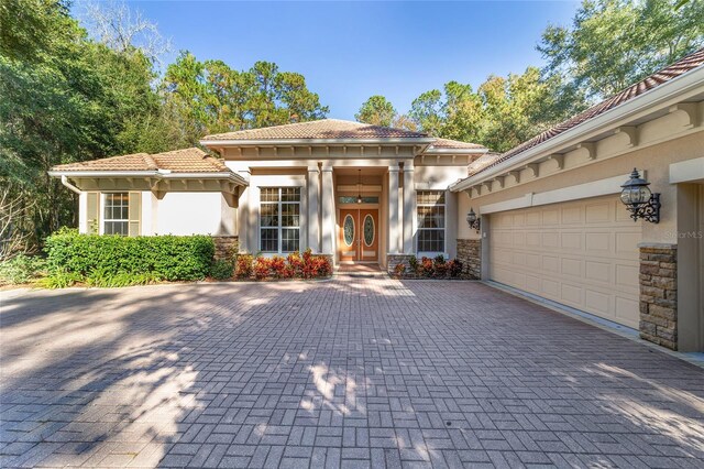 mediterranean / spanish-style house with a garage