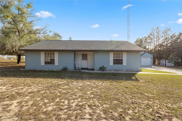 single story home with a garage, an outdoor structure, and a front lawn