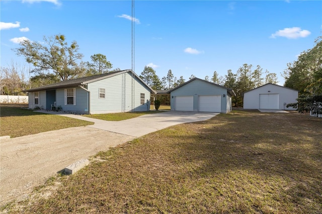 view of side of property with a lawn, an outdoor structure, and a garage