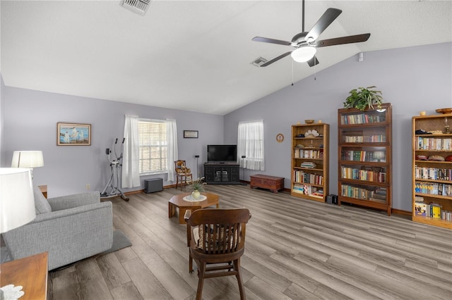 living room featuring light hardwood / wood-style flooring, ceiling fan, and lofted ceiling