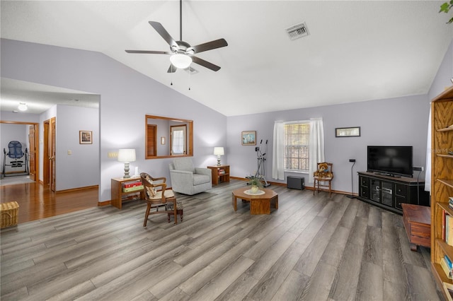 living room featuring ceiling fan, light hardwood / wood-style flooring, and lofted ceiling