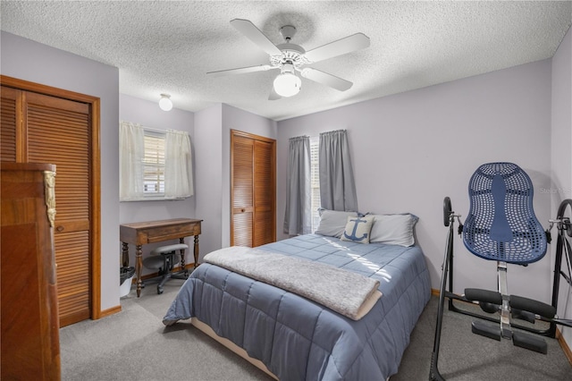 carpeted bedroom featuring a textured ceiling and ceiling fan