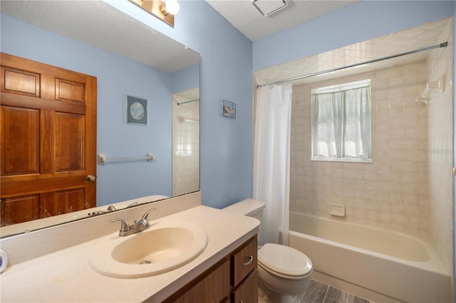 full bathroom featuring vanity, toilet, a textured ceiling, and shower / tub combo with curtain