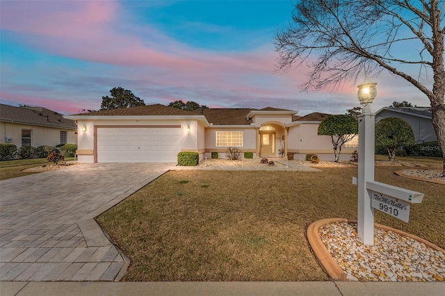 view of front of property featuring a yard and a garage