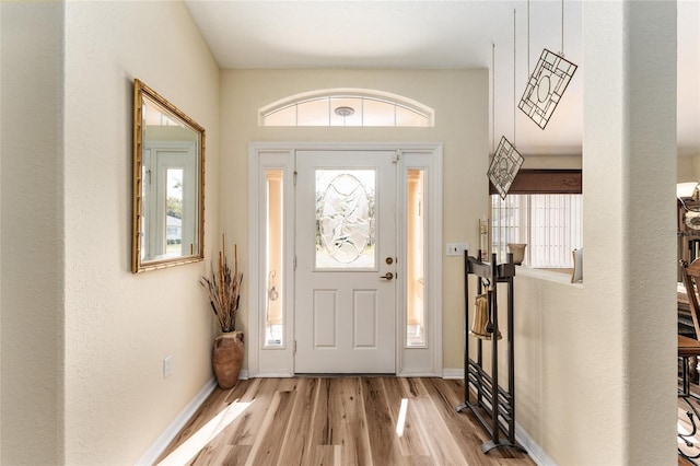 entryway with light wood-type flooring and a wealth of natural light