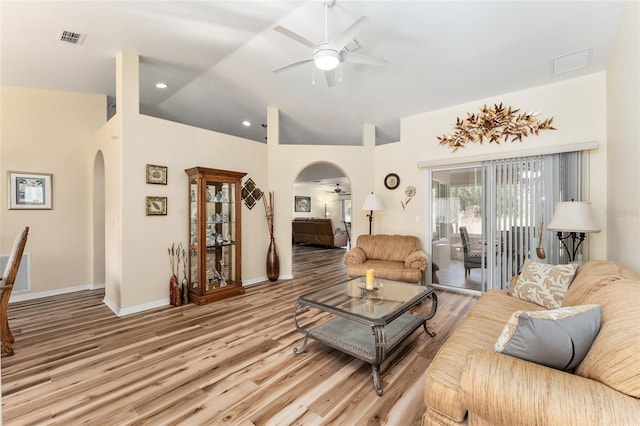 living room with vaulted ceiling, light hardwood / wood-style flooring, and ceiling fan