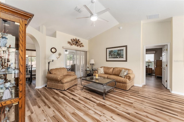 living room featuring ceiling fan, vaulted ceiling, and light hardwood / wood-style flooring