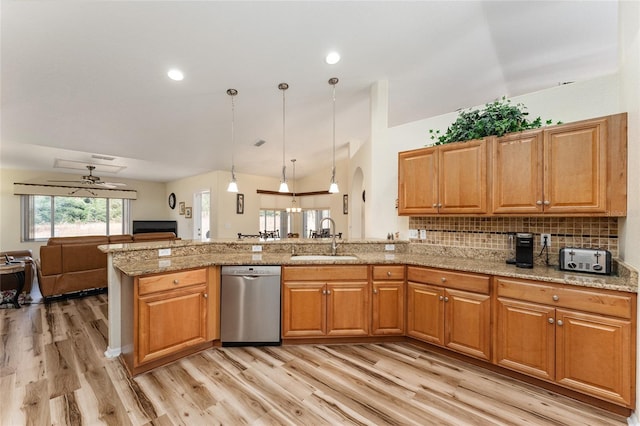 kitchen featuring dishwasher, sink, light hardwood / wood-style flooring, backsplash, and decorative light fixtures