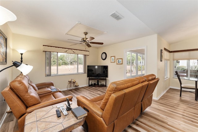 living room featuring ceiling fan and light hardwood / wood-style flooring