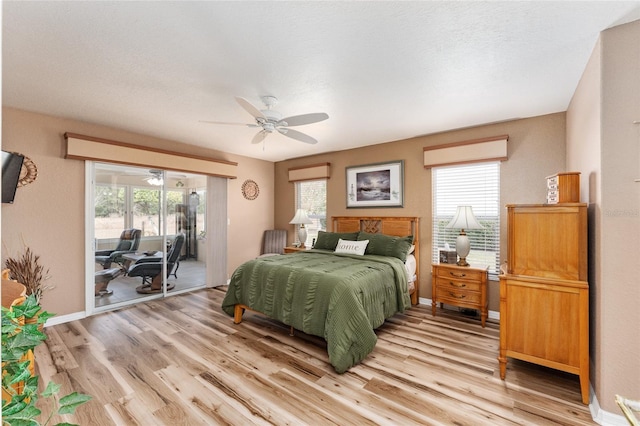 bedroom featuring ceiling fan, light wood-type flooring, access to outside, and multiple windows