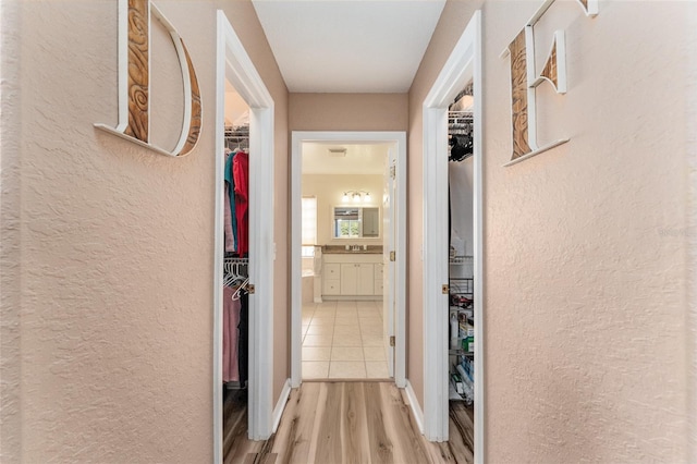 hall featuring light wood-type flooring and sink