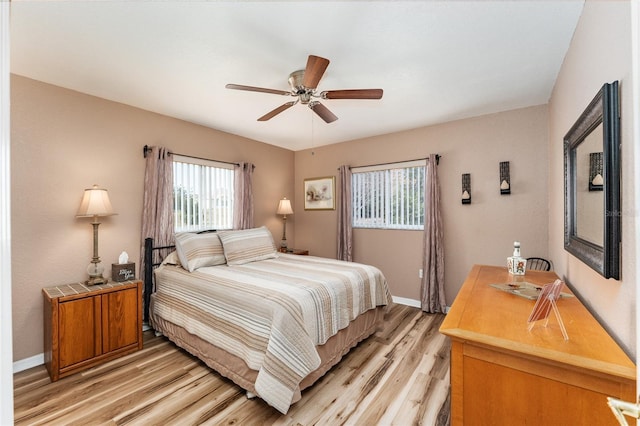 bedroom with ceiling fan and light hardwood / wood-style floors