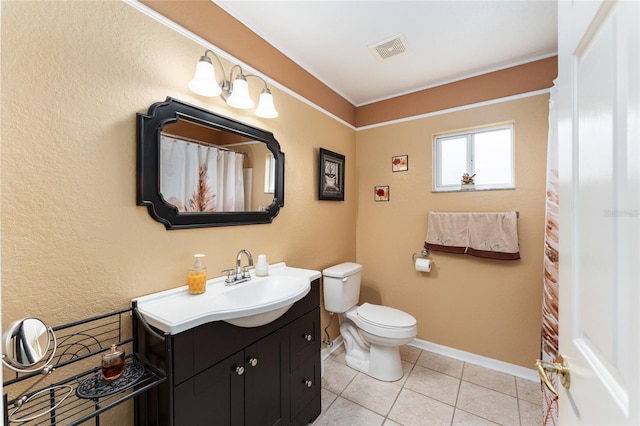 bathroom with tile patterned flooring, vanity, and toilet